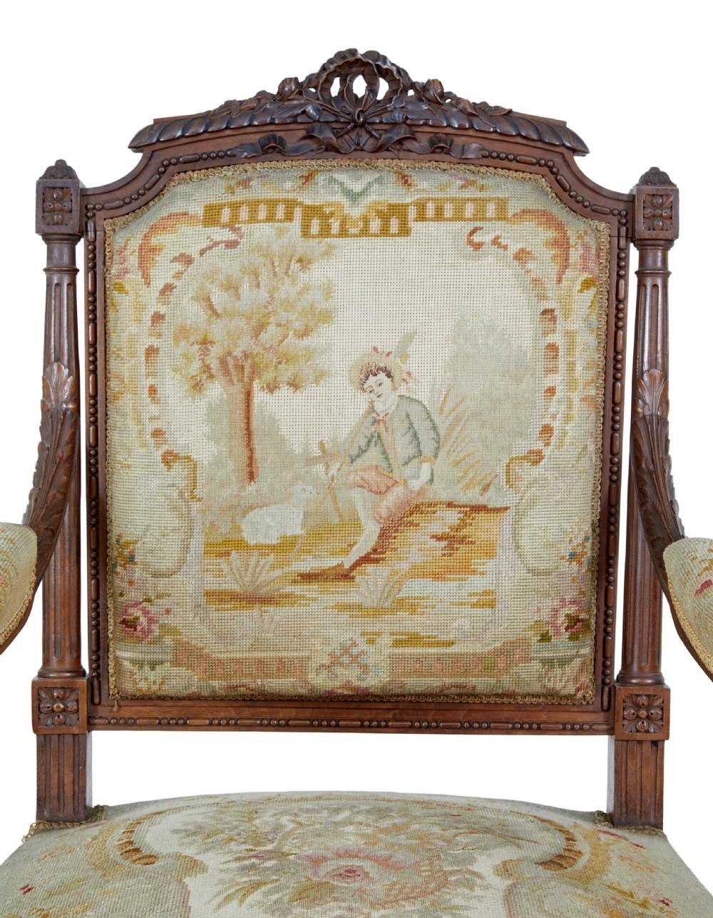 A pair of 19th-century French carved walnut armchairs upholstered in woven tapestry fabric featuring pastoral scenes and fluted turned legs. View VI