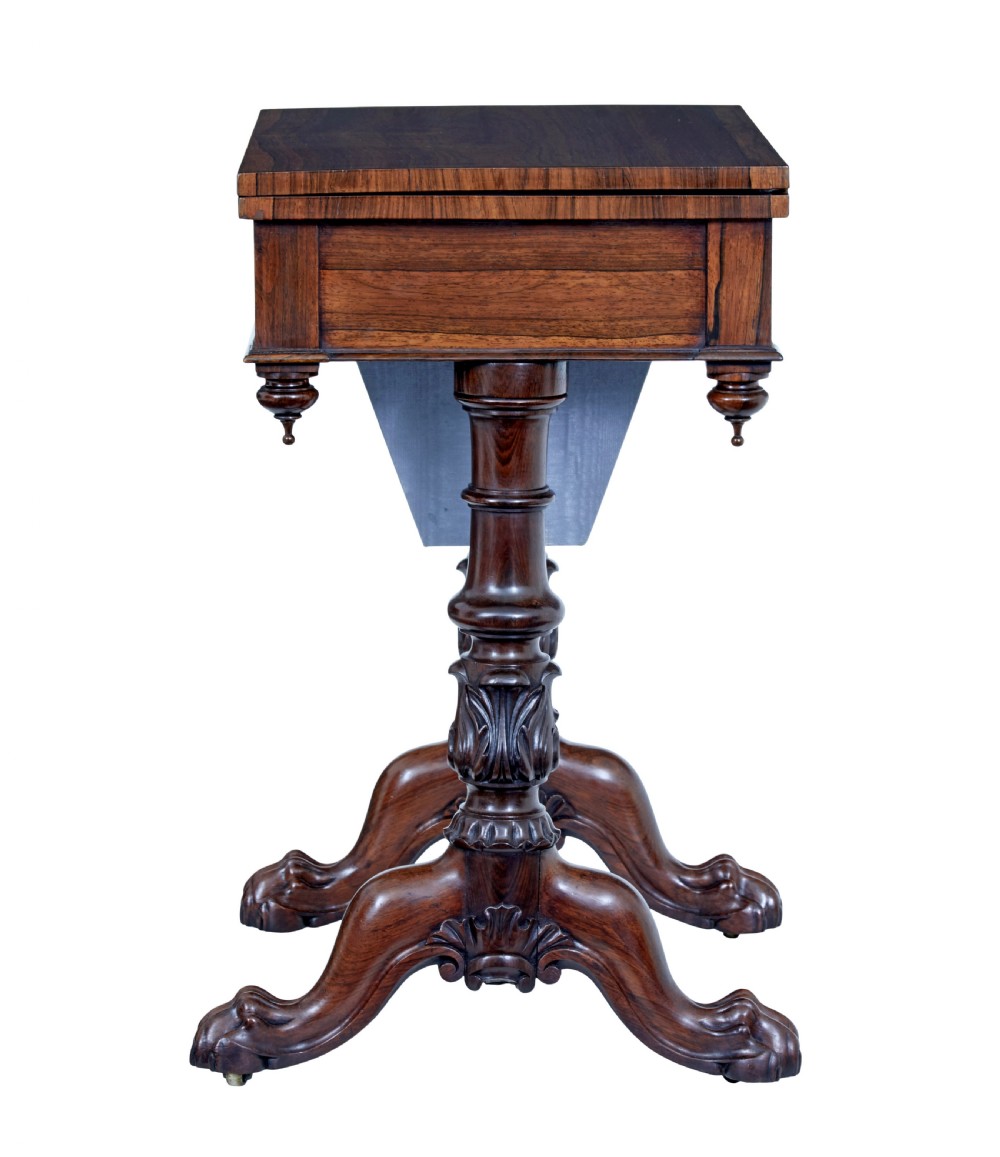 A 19th-century William IV palisander flip-top side table featuring carved legs, claw feet, a single drawer, and a suspended work well beneath. View V