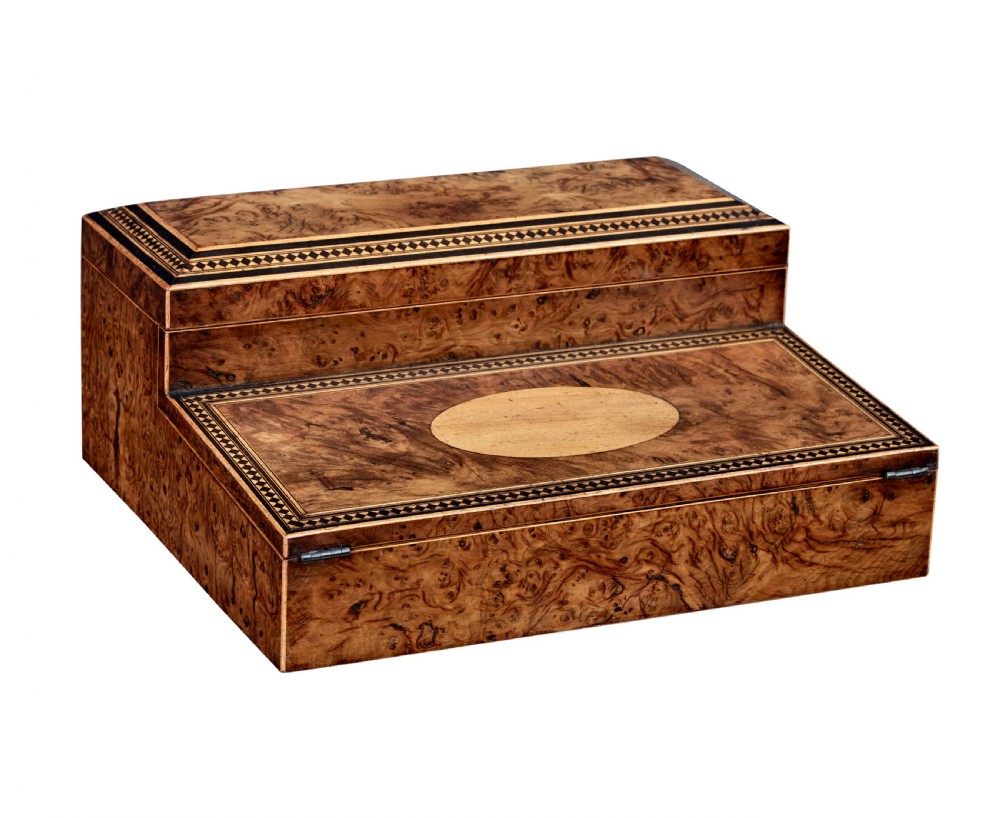 A nineteenth-century Victorian burr walnut writing slope featuring geometric inlaid border banding and a central oval cartouche.
