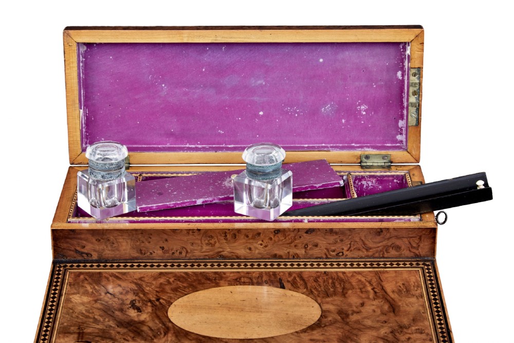 A nineteenth-century Victorian burr walnut writing slope featuring geometric inlaid border banding and a central oval cartouche. View V
