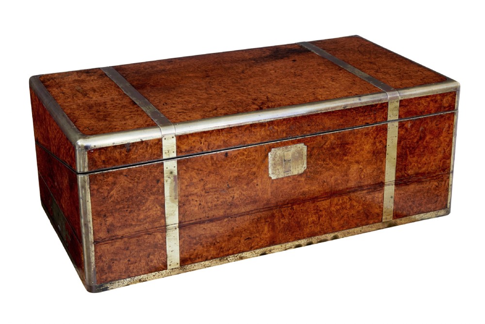 A closed mid-19th-century burr walnut campaign lap writing desk with flush brass corner brackets and brass strapping.