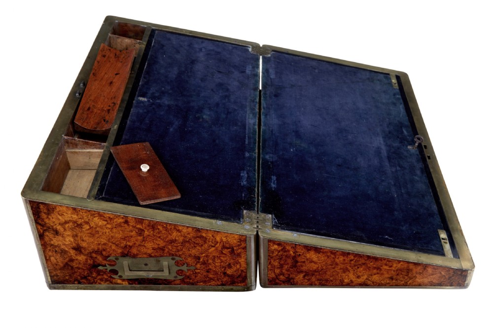 A closed mid-19th-century burr walnut campaign lap writing desk with flush brass corner brackets and brass strapping. View V