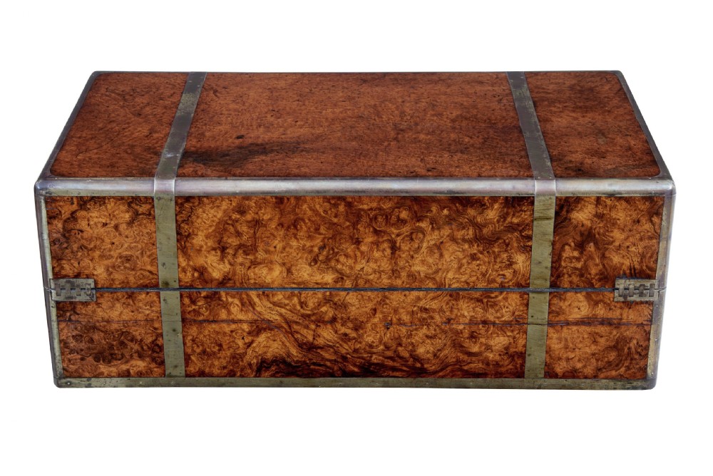 A closed mid-19th-century burr walnut campaign lap writing desk with flush brass corner brackets and brass strapping. View VI