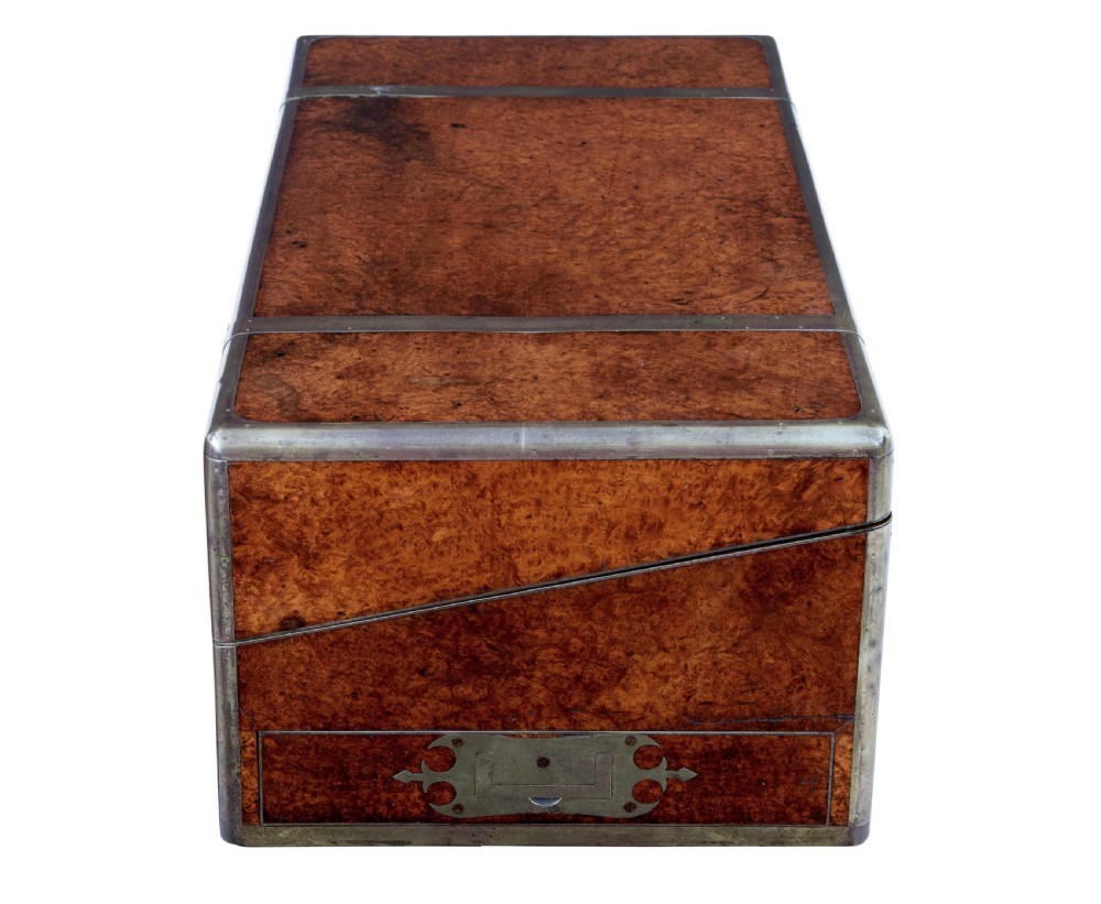 A closed mid-19th-century burr walnut campaign lap writing desk with flush brass corner brackets and brass strapping. View VII