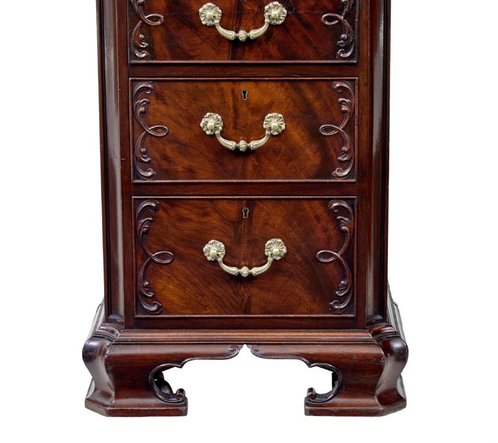 An early 20th-century mahogany pedestal desk featuring nine carved drawers with brass handles, a leather inset top, and bracket feet. View VIII