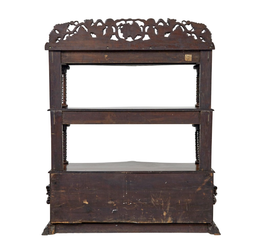 A 19th-century dark oak Victorian buffet featuring three tiers, intricate grapevine relief carvings, turned support columns, and a lower double-door cupboard. View VII