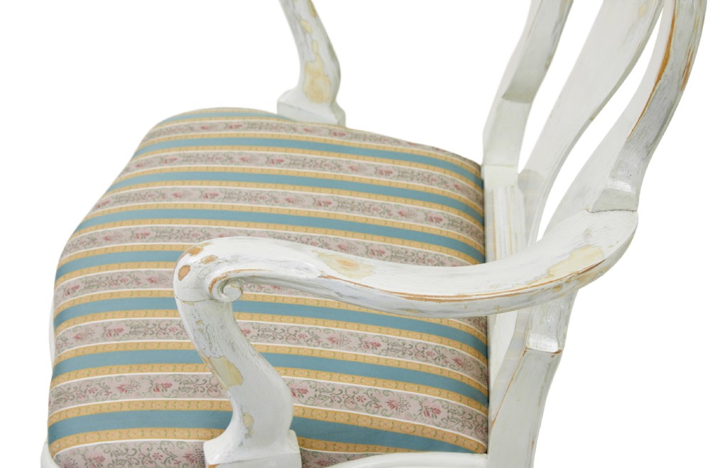 A set of fourteen distressed off-white lacquered Queen Anne style dining chairs featuring vasiform splats, cabriole legs, and striped textile upholstery. View VII