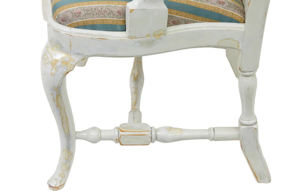 A set of fourteen distressed off-white lacquered Queen Anne style dining chairs featuring vasiform splats, cabriole legs, and striped textile upholstery. View X