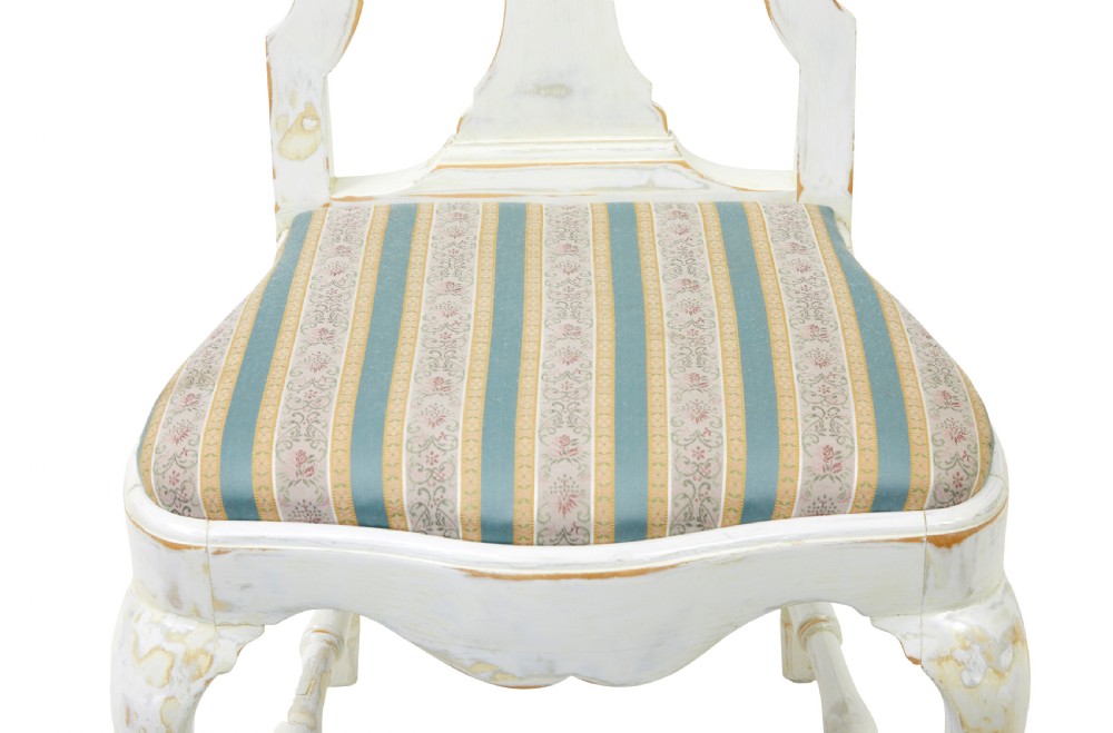 A set of fourteen distressed off-white lacquered Queen Anne style dining chairs featuring vasiform splats, cabriole legs, and striped textile upholstery. View XI