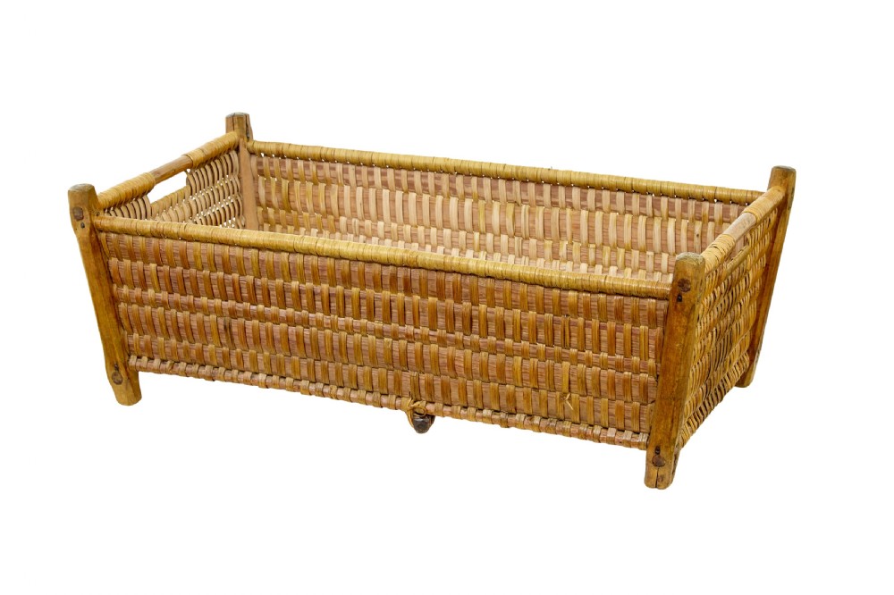 A rectangular nineteenth-century Scandinavian basket constructed from woven pine splints with raised wooden corner supports.