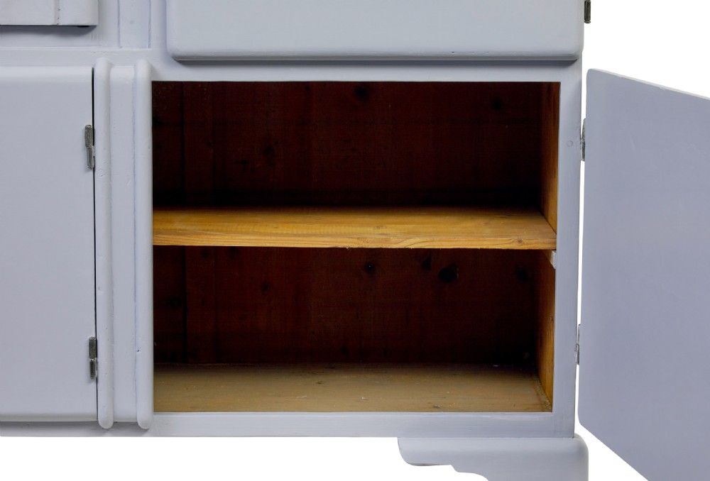 A pale blue-grey painted pine kitchen sideboard featuring five panelled cupboard doors and two central stacked drawers. View IV