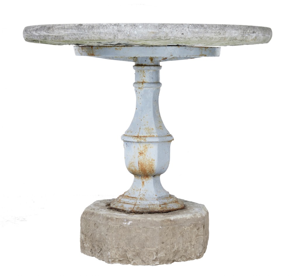 A 19th-century Swedish garden table featuring a circular stone top above a light blue painted cast iron baluster pedestal set into a heavy stone base.