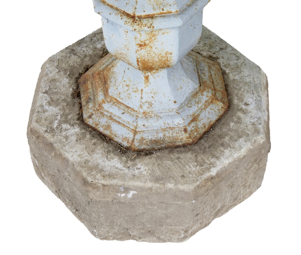 A 19th-century Swedish garden table featuring a circular stone top above a light blue painted cast iron baluster pedestal set into a heavy stone base. View IV