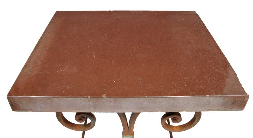A 1920s French baker table with a thick red marble slab top resting on a scrollwork wrought iron frame. View V