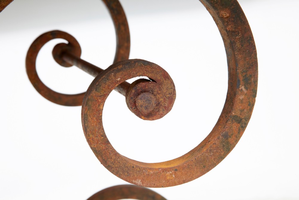 A 1920s French baker table with a thick red marble slab top resting on a scrollwork wrought iron frame. View VI
