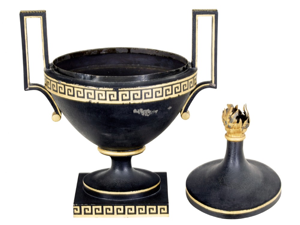 An early 19th-century black painted metal toleware urn with gilded Greek key decoration, angular handles, and a flame finial on a square plinth. View IV