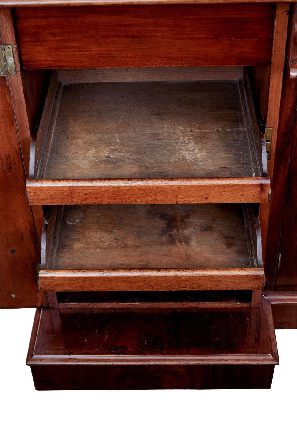 A Victorian flame mahogany sideboard featuring a carved botanical frame around an oval mirror top above cupboard doors and pedestal bases. View IX