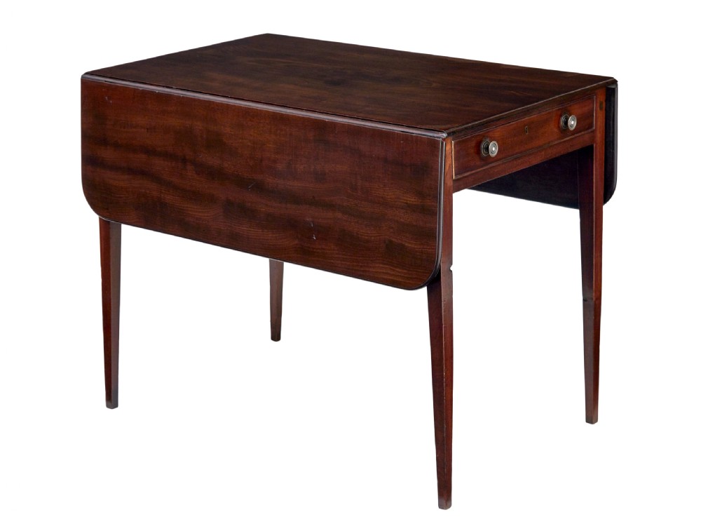 An early 19th-century mahogany Pembroke table featuring two drop-leaf flaps, a single end drawer with circular brass pull handles, and square tapered legs.