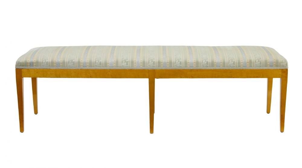An early 20th-century Swedish long stool made of light honey-coloured birch wood with six square tapered legs and light blue striped upholstered seat. View II