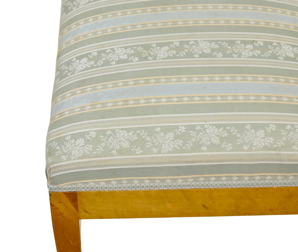 An early 20th-century Swedish long stool made of light honey-coloured birch wood with six square tapered legs and light blue striped upholstered seat. View VII