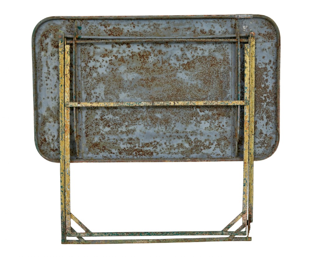 A rectangular folding metal garden table featuring a heavily distressed, multi-coloured painted surface and an X-frame iron base. View II