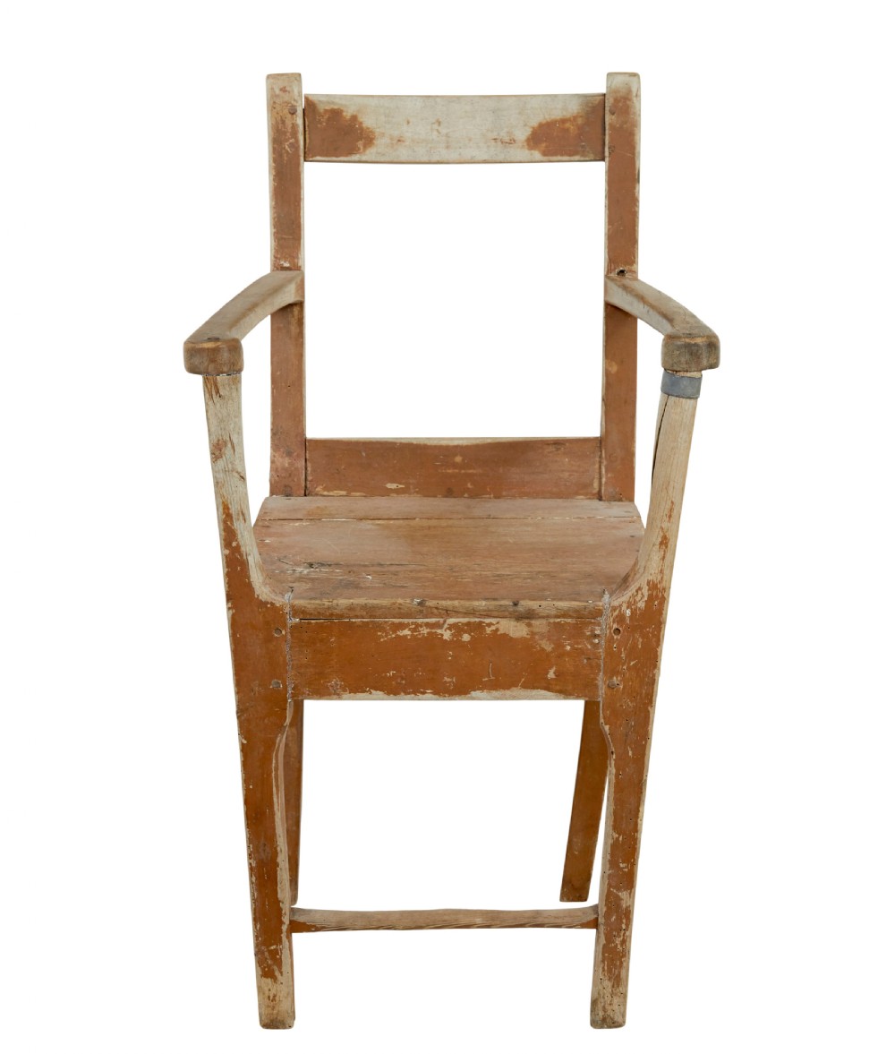 An early nineteenth-century Swedish childs armchair featuring a distressed reddish-brown painted finish over pine, straight legs, and flat armrests.