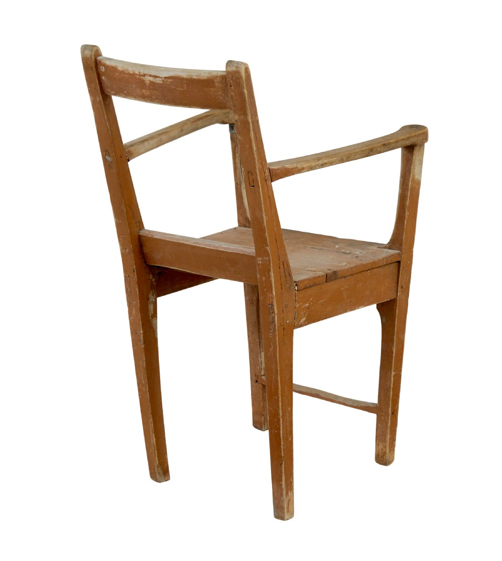 An early nineteenth-century Swedish childs armchair featuring a distressed reddish-brown painted finish over pine, straight legs, and flat armrests. View V