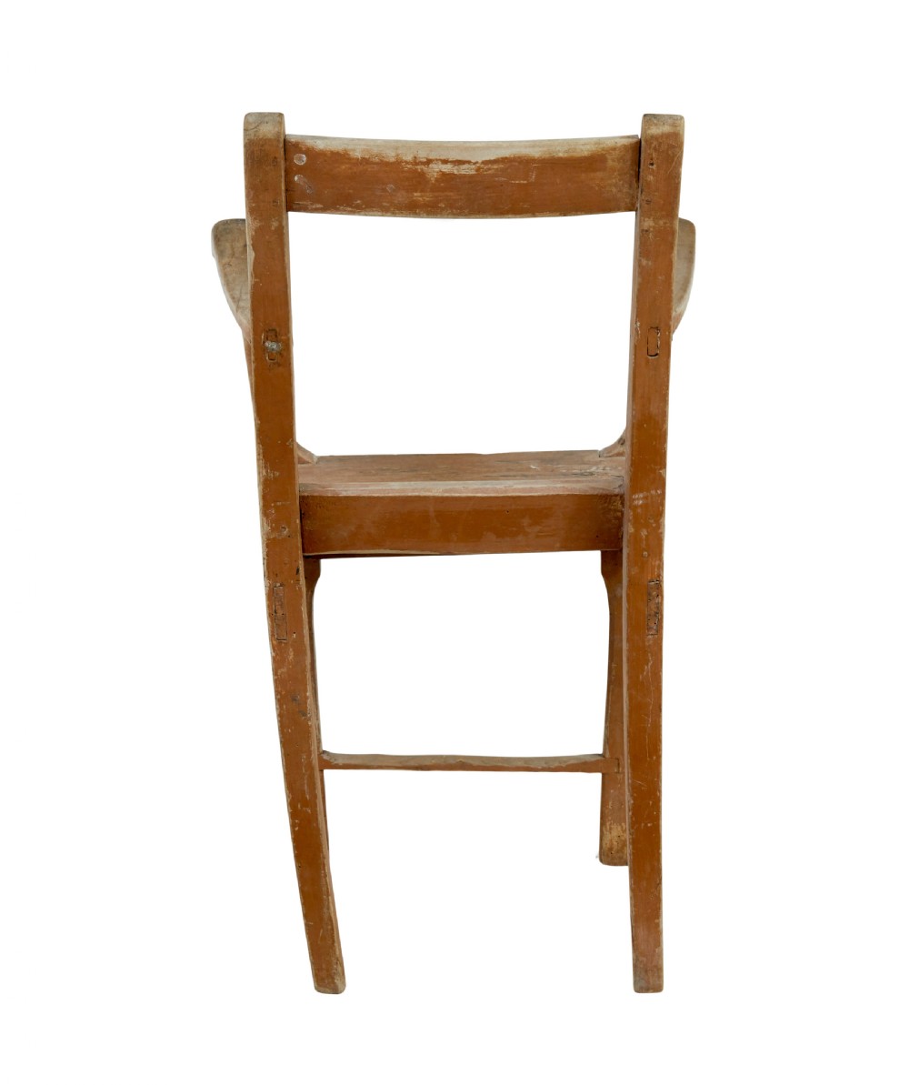 An early nineteenth-century Swedish childs armchair featuring a distressed reddish-brown painted finish over pine, straight legs, and flat armrests. View VI