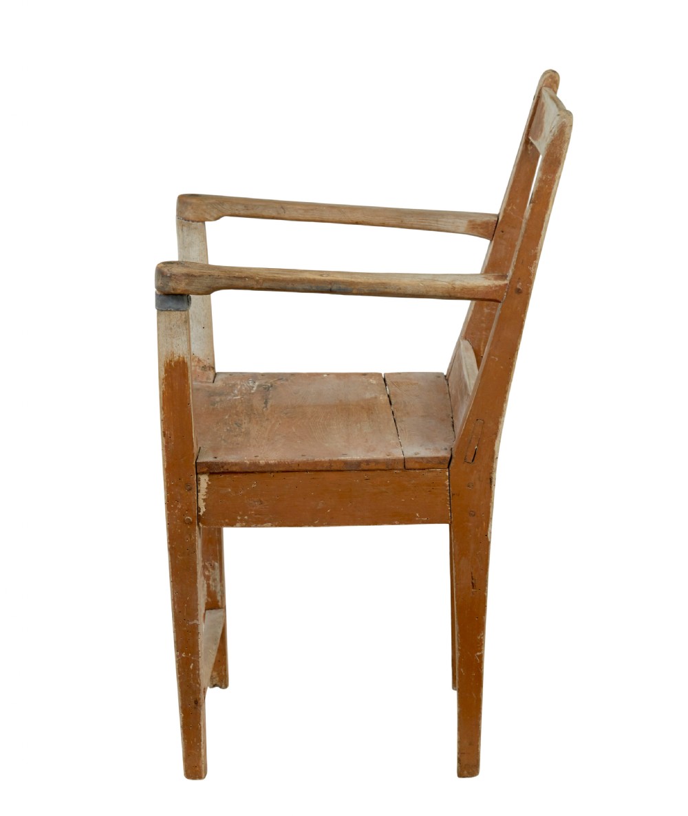 An early nineteenth-century Swedish childs armchair featuring a distressed reddish-brown painted finish over pine, straight legs, and flat armrests. View VII