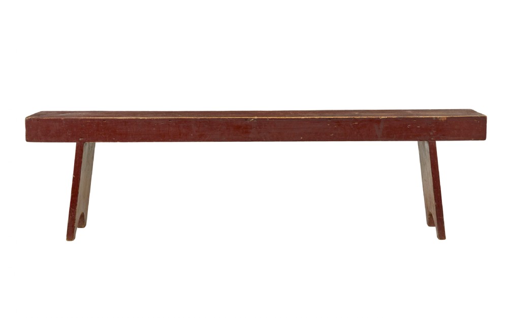 A long 19th-century Swedish pine bench painted in a distressed red finish with slab trestle legs featuring arched cut-outs. View II
