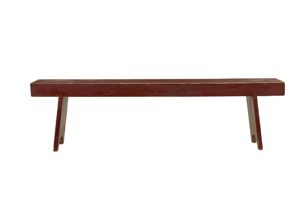 A long 19th-century Swedish pine bench painted in a distressed red finish with slab trestle legs featuring arched cut-outs. View III