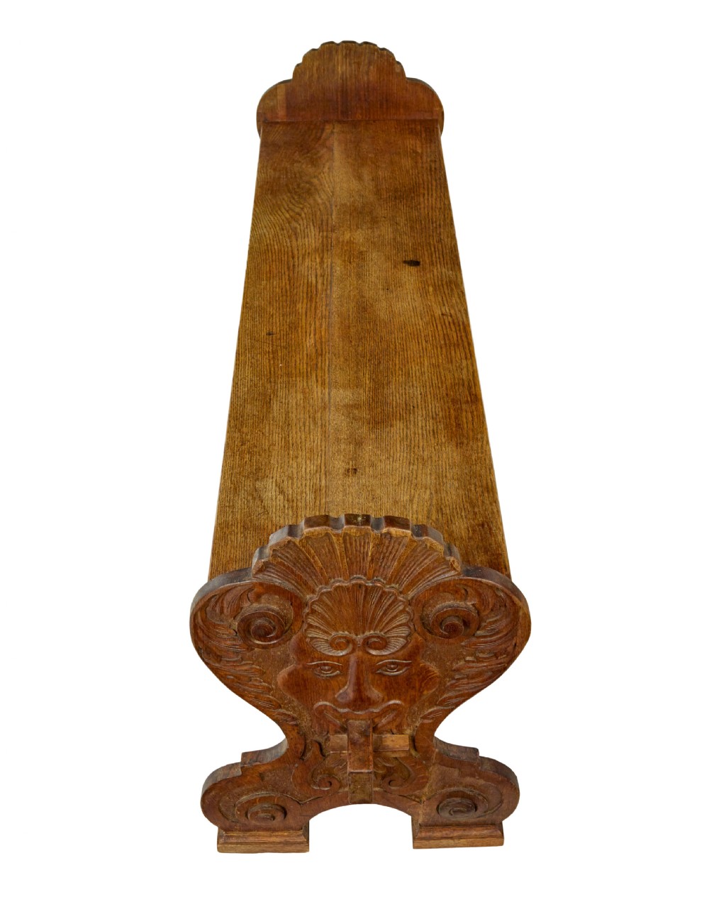 A 19th-century carved oak dining table flanked by two matching wooden benches with relief carvings on the trestle end supports. View VIII