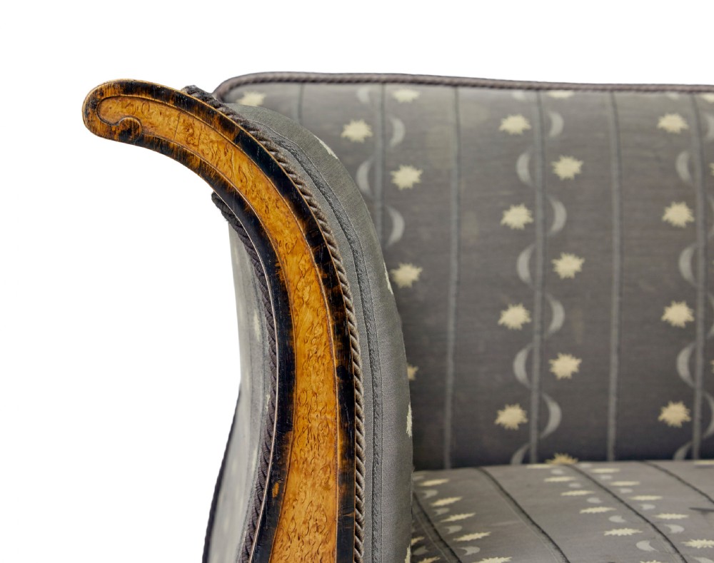 A pair of Art Deco armchairs featuring flared burr birch frames, grey upholstered cushions with a pattern motif, and ebonised carved feet. View VI