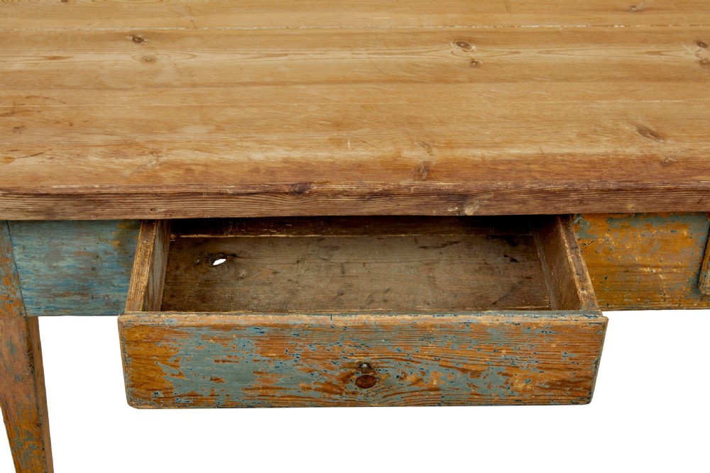 A mid 19th-century Swedish pine bakers table featuring two drawers, tapered square legs, and a distressed blue painted finish with a scrubbed wooden top. View IX