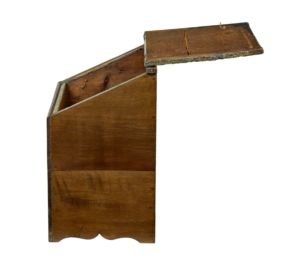 A 19th-century oak sloped-top storage box featuring an embossed brass lid panel depicting figures on horseback and a scalloped wooden base. View IV