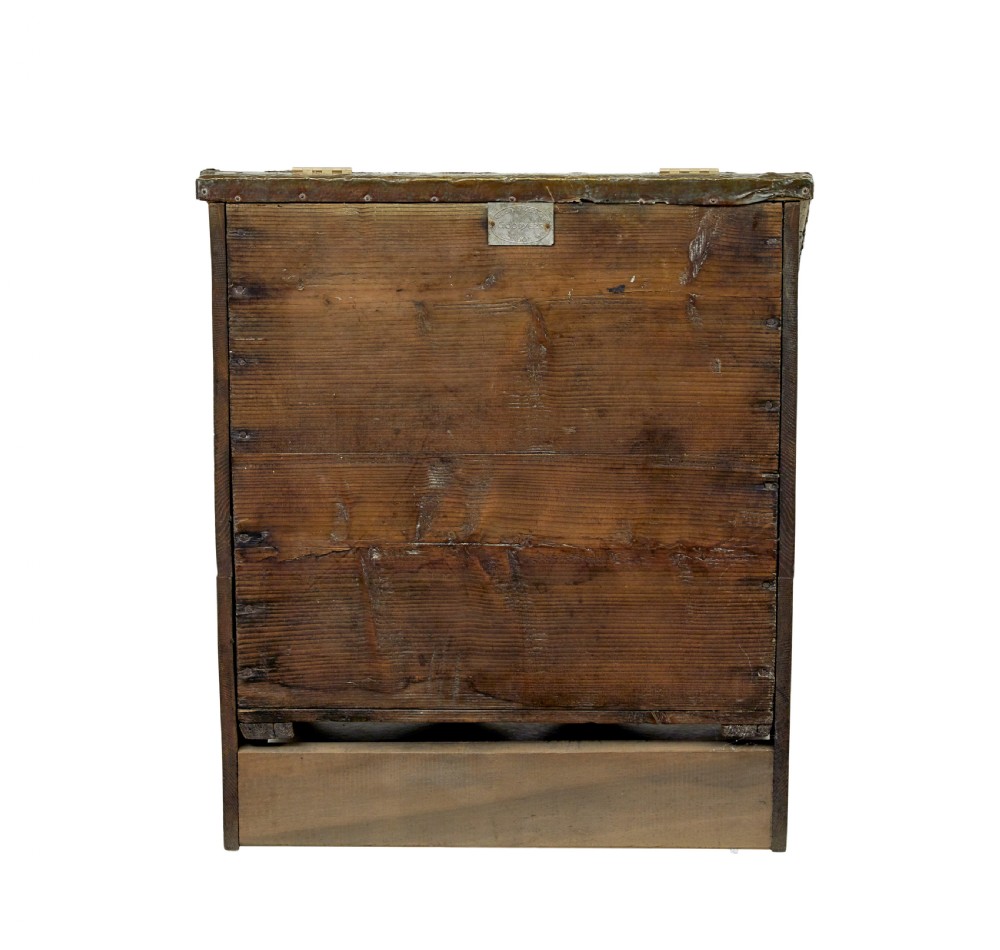 A 19th-century oak sloped-top storage box featuring an embossed brass lid panel depicting figures on horseback and a scalloped wooden base. View V