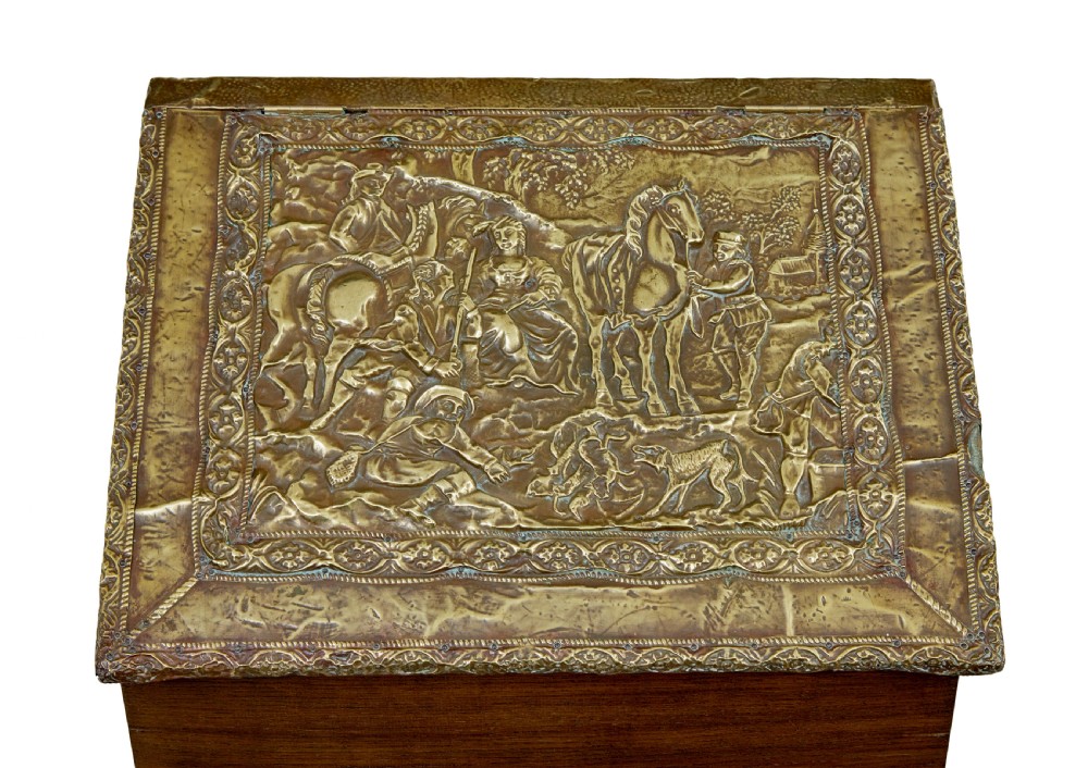 A 19th-century oak sloped-top storage box featuring an embossed brass lid panel depicting figures on horseback and a scalloped wooden base. View VII