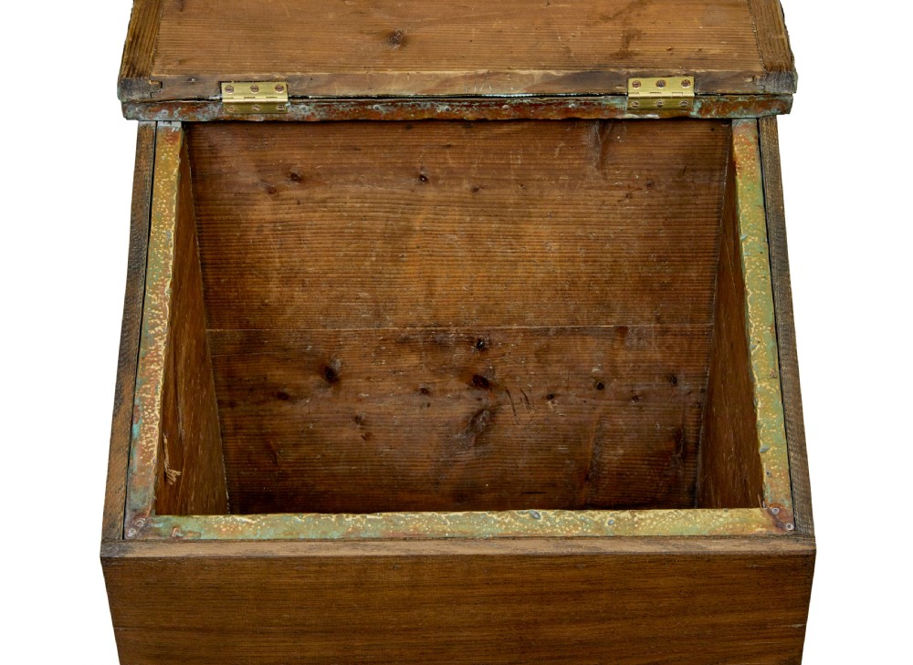 A 19th-century oak sloped-top storage box featuring an embossed brass lid panel depicting figures on horseback and a scalloped wooden base. View VIII