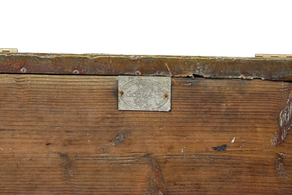 A 19th-century oak sloped-top storage box featuring an embossed brass lid panel depicting figures on horseback and a scalloped wooden base. View IX