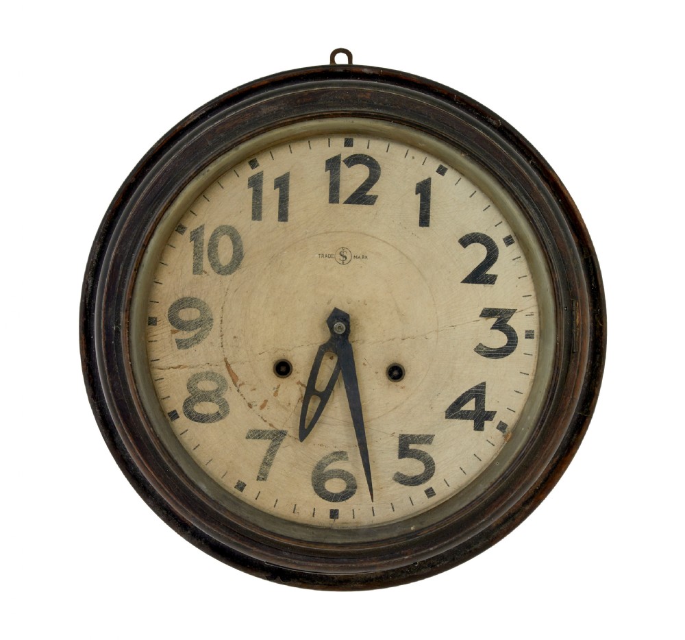 A circular vintage Japanese wall clock featuring a dark wooden bezel and an off-white dial with black Arabic numerals.
