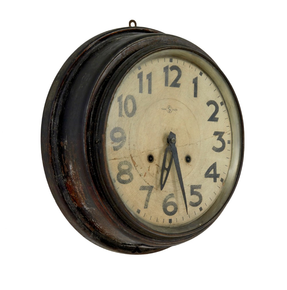 A circular vintage Japanese wall clock featuring a dark wooden bezel and an off-white dial with black Arabic numerals. View III