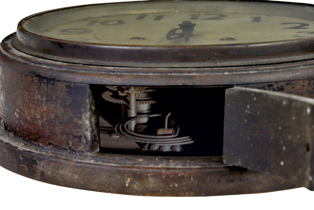 A circular vintage Japanese wall clock featuring a dark wooden bezel and an off-white dial with black Arabic numerals. View VI