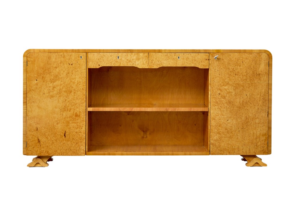 A low Scandinavian Art Deco open bookcase in golden burr elm with rounded upper corners, flanked cupboards, open central shelves, and sculpted feet. View II