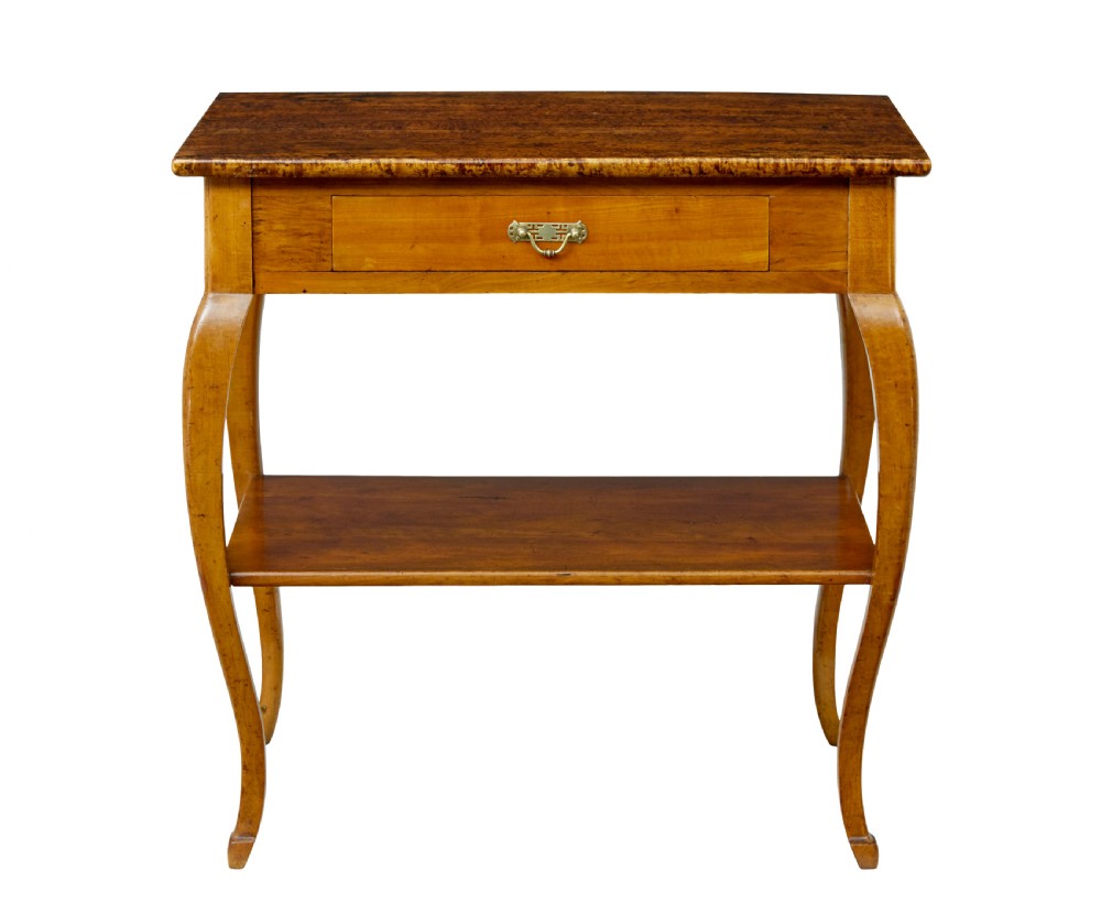 A 19th-century fruitwood and alder occasional table featuring curved legs, a single drawer with a brass handle, a lower shelf, and a figured wood top.