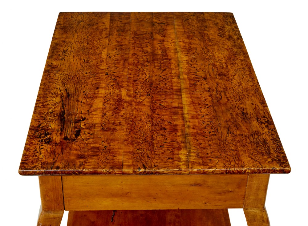 A 19th-century fruitwood and alder occasional table featuring curved legs, a single drawer with a brass handle, a lower shelf, and a figured wood top. View II