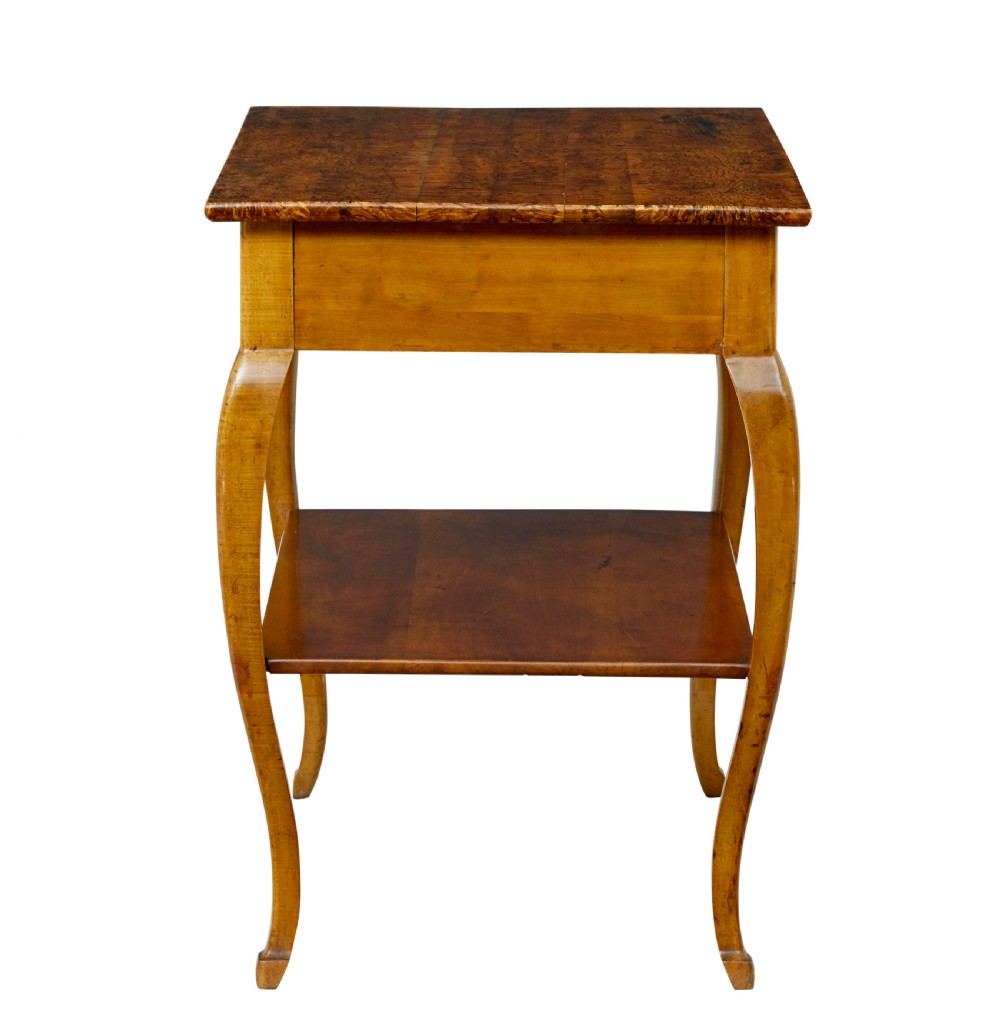 A 19th-century fruitwood and alder occasional table featuring curved legs, a single drawer with a brass handle, a lower shelf, and a figured wood top. View VI