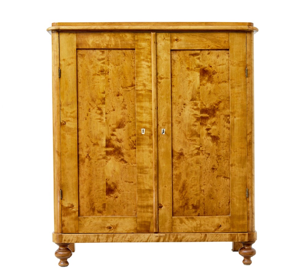 A 19th-century Swedish double-door cupboard crafted from highly figured golden birch timber with turned front feet. View II