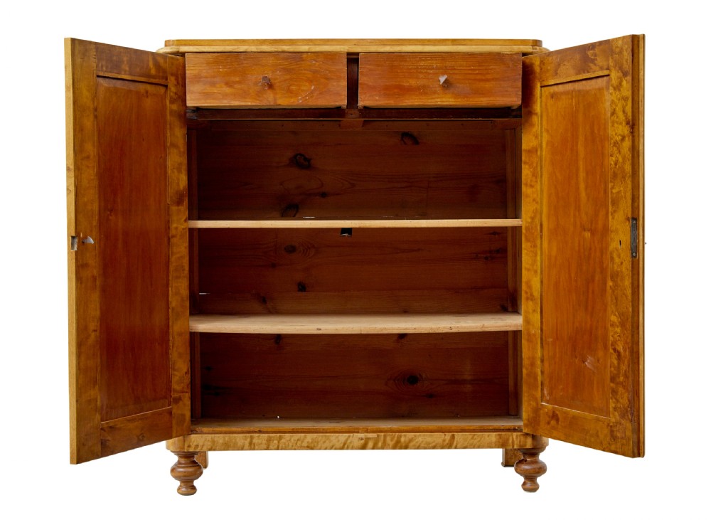 A 19th-century Swedish double-door cupboard crafted from highly figured golden birch timber with turned front feet. View III