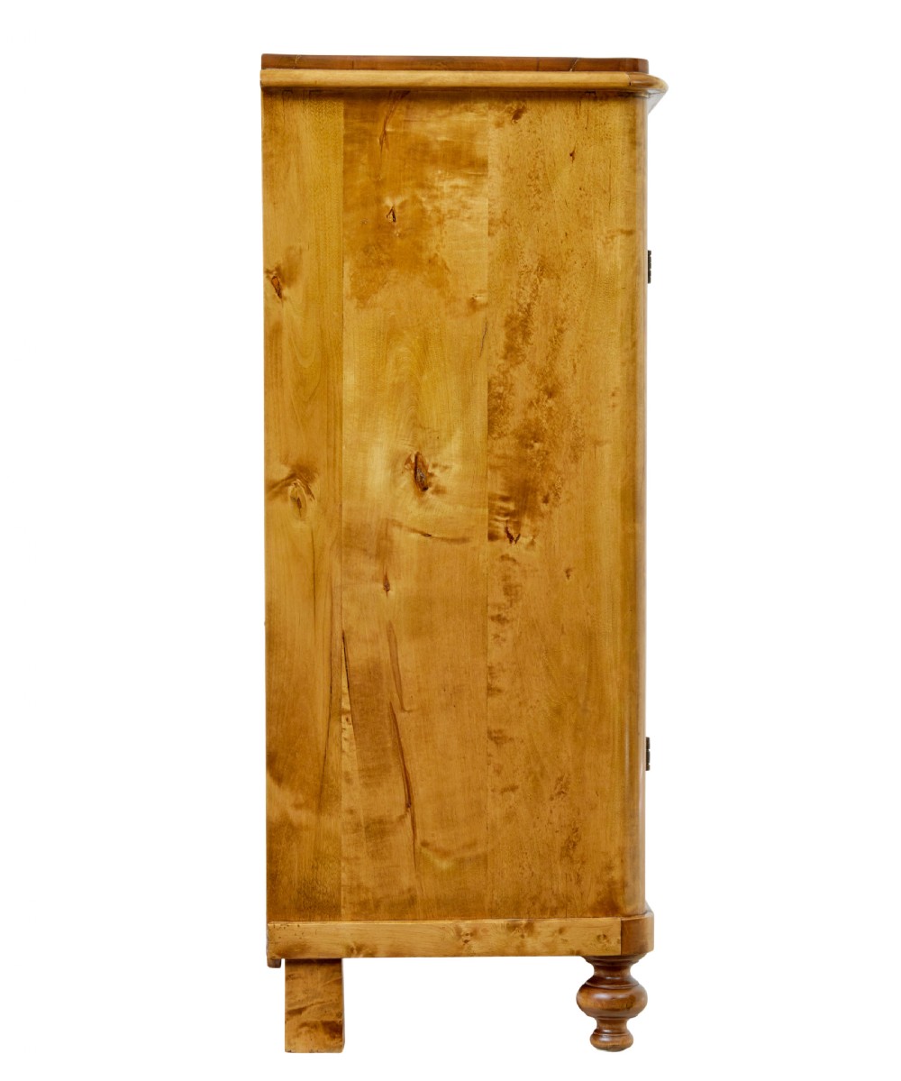 A 19th-century Swedish double-door cupboard crafted from highly figured golden birch timber with turned front feet. View IV
