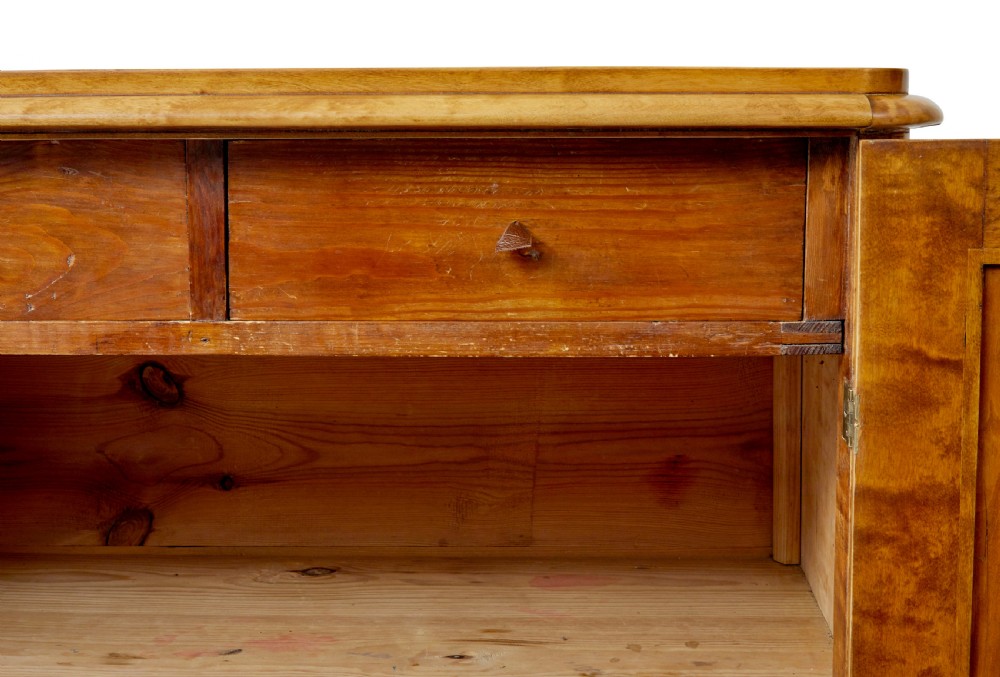 A 19th-century Swedish double-door cupboard crafted from highly figured golden birch timber with turned front feet. View VII